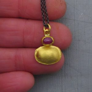 Ruby 24 karat gold pendant with silver necklace