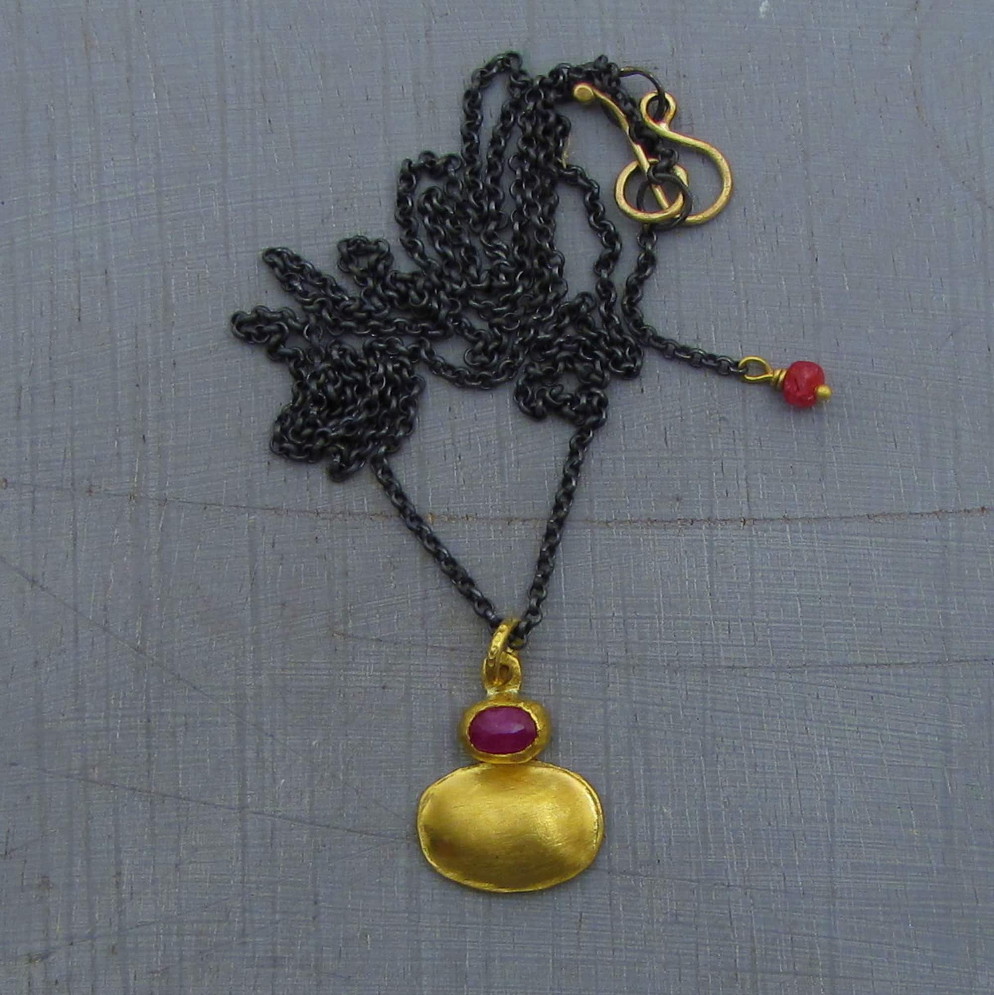 Ruby 24 karat gold pendant with silver necklace