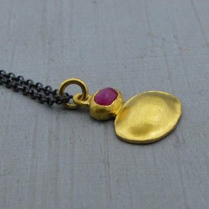 Ruby 24 karat gold pendant with silver necklace