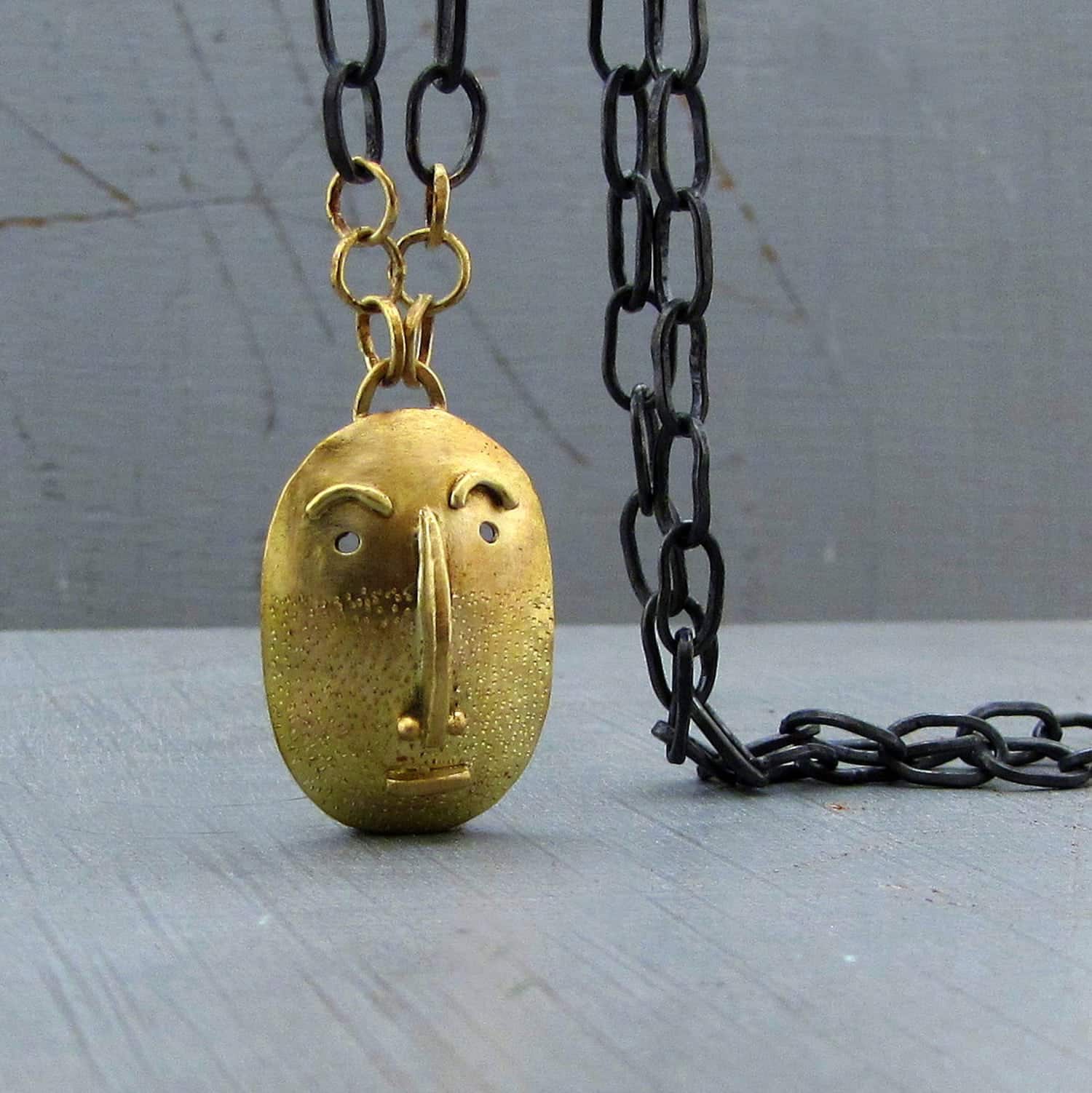 Handmade solid 14k gold Face pendant on a silver chain