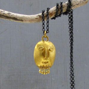 22k gold pendant shaped as tribal style face