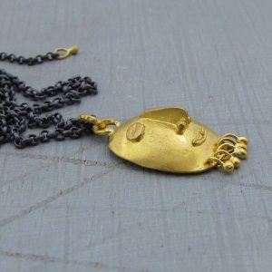 22k gold pendant shaped as tribal style face