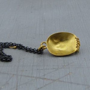 22k gold pendant shaped as tribal style face