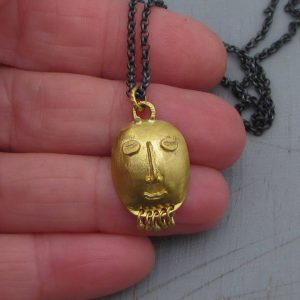 22k gold pendant shaped as tribal style face