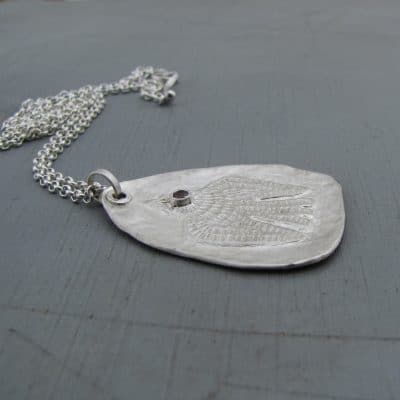 Handmade textured artisan silver necklace with pink eye bird